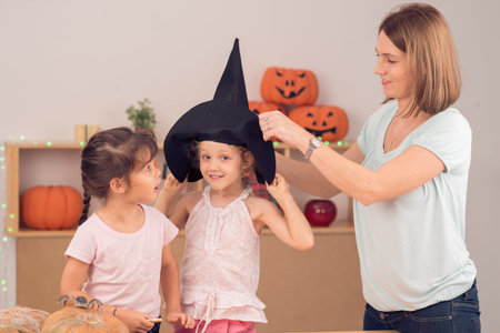 Mother and daughters preparing for Halloween party