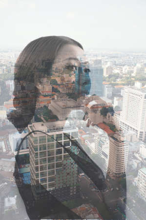 Double exposure portrait of young pensive womanの写真素材