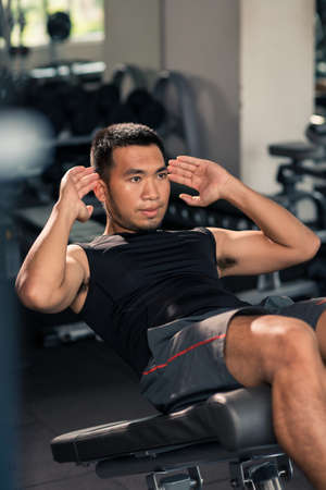 Sportsman working on his abdominal muscles in the gymの写真素材