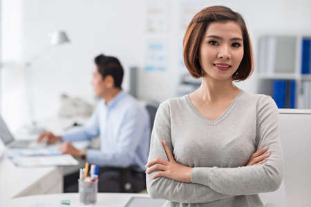 Pretty confident business woman standing with her arms foldedの写真素材