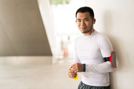 Handsome runner having break and drinking some juiceの写真素材