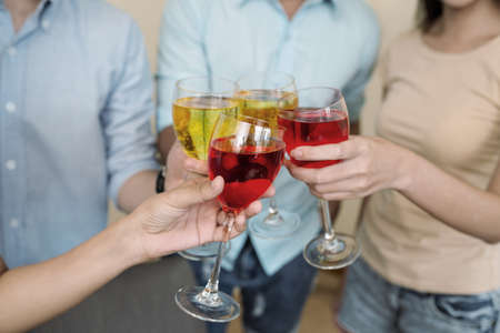 Close-up image of friends clinking glasses at the partyの写真素材