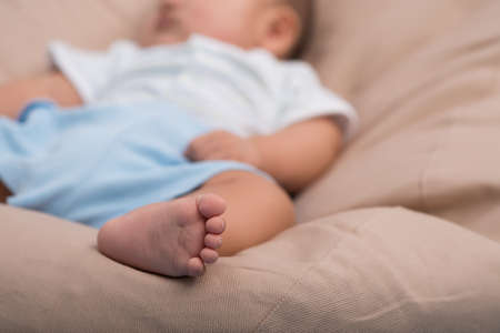 Sweet sleeping infant, focus on little footの写真素材