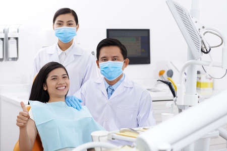 Portrait of dental clinic personnel and happy patientの写真素材