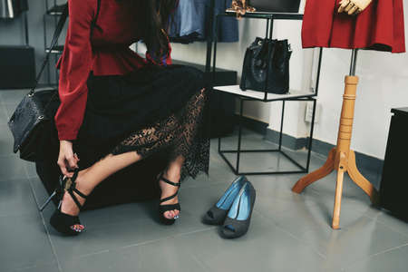 Cropped image of fashionable woman trying on high heelsの写真素材