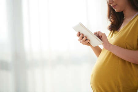 Pregnant woman with tabletの写真素材