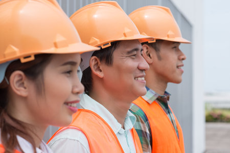 Group of Asian architects standing in a row, focus on contractor