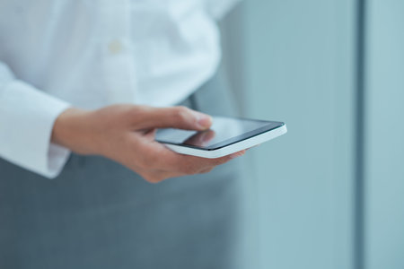 Business woman text messaging with her smartphone, selective focus