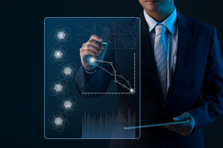 Business person with a digital tablet drawing chart on virtual screen