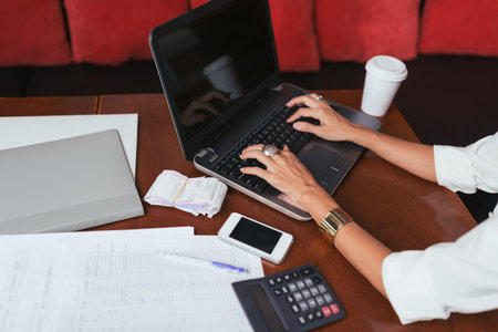 Hands of female accountant working on laptop, selective focusの写真素材