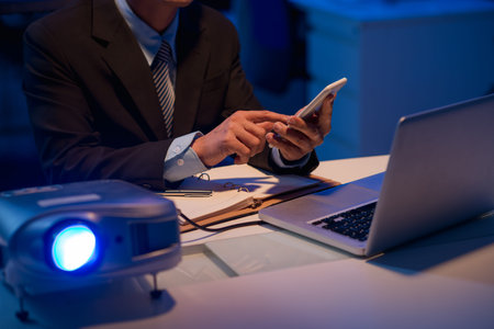 Cropped image of businessman using remote control of led projector