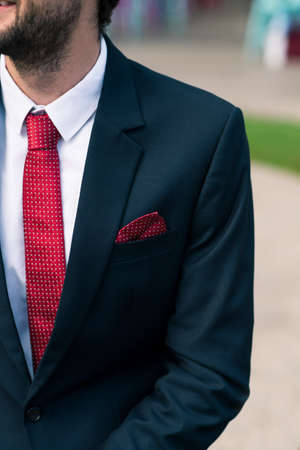 Cropped image of gentleman wearing suit and red necktieの写真素材