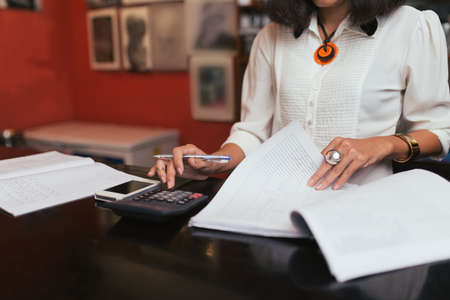 Cropped image of accountant or shop owner counting incomeの写真素材