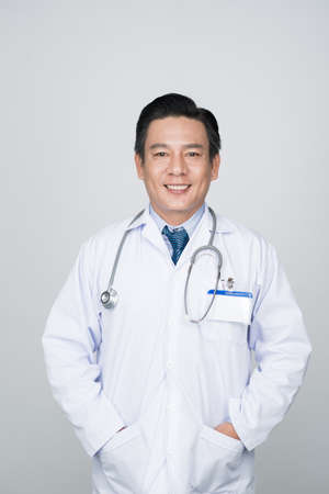 Portrait of confident smiling doctor, isolated on whiteの写真素材