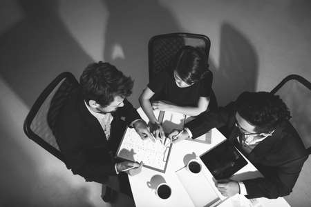 High angle view of three managers at meetingの写真素材