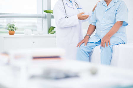 Doctor talking to her patient at wardの写真素材