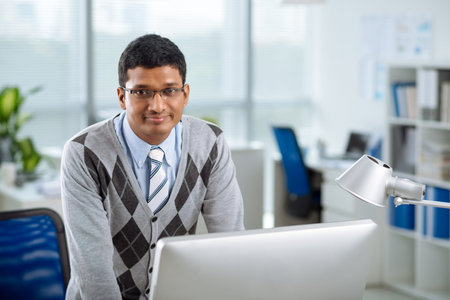 Portrait of smiling Indian office worker looking at the cameraの写真素材