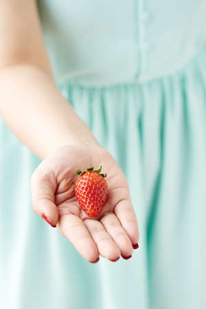Take a strawberryの写真素材