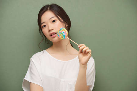 Enjoying lollipopの写真素材