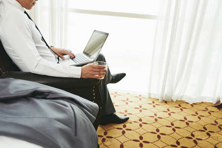 Relaxing with glass of whiskeyの写真素材