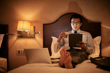 Working in bedの写真素材