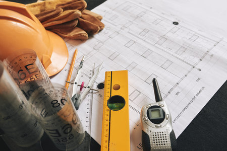 Different belongings of engineer on blueprint of buildingの写真素材
