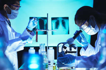 Laboratory workers trying to find solution against lungs diseaseの写真素材