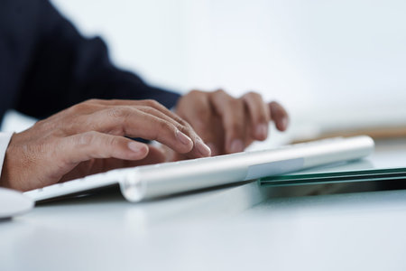 Hands of business person computing, selective focus
