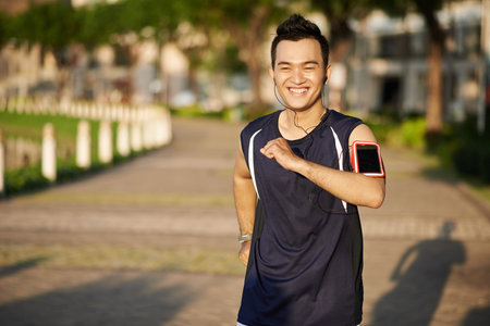 Vietnamese man enjoying jogging in the morningの写真素材