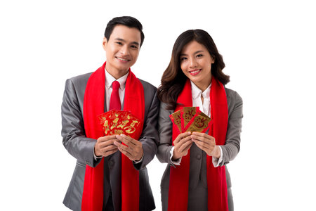 Vietnamese business couple showing red envelopes with money  attribute of Tet celebrationの写真素材
