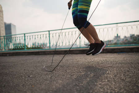 Legs of female athlete with jump rope training outdoorsの写真素材