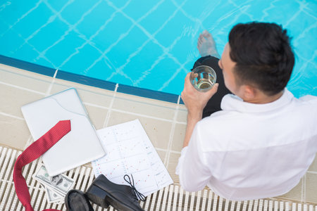 Entrepreneur enjoying his time at the swimming pool