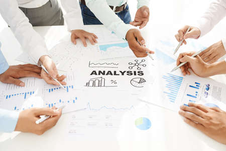 Hands of business people analyzing charts and graphsの写真素材