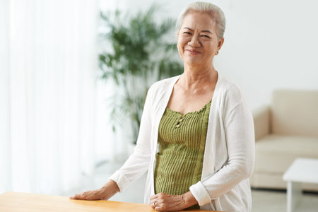 Happy senior female in casual-wear looking at cameraの写真素材