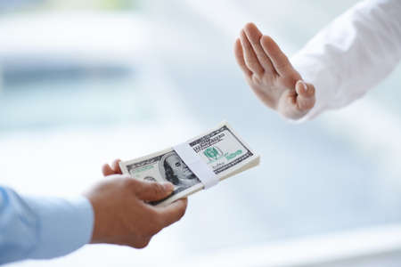 Businessman refuses to take bribeの写真素材