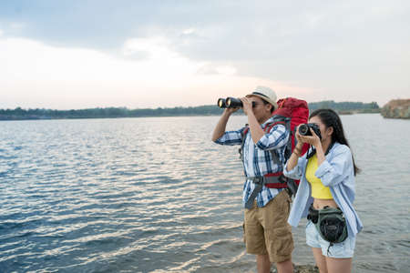 Hikers watching the view of the lakeの写真素材