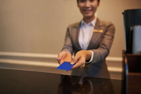 Hotel manager giving electronic key to customerの写真素材