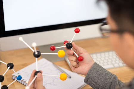 Hands of biotechnologist analyzing molecular structureの写真素材