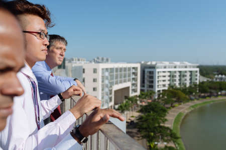 Ambitious business team at the rooftop looking at the cityの写真素材