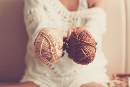 Close-up of yarn balls in female handsの写真素材
