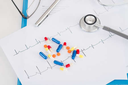 Bright pills and tablets on cardiogram: heart diseaseの写真素材