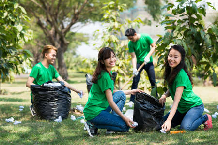 Team of activists collecting litter in the parkの写真素材