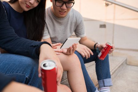 Close-up image of friends watching photos on smartphone