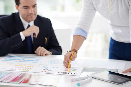 Designer showing different variants of logo to clientの写真素材