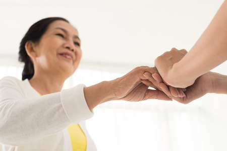 Doctor comforting mature female patientの写真素材