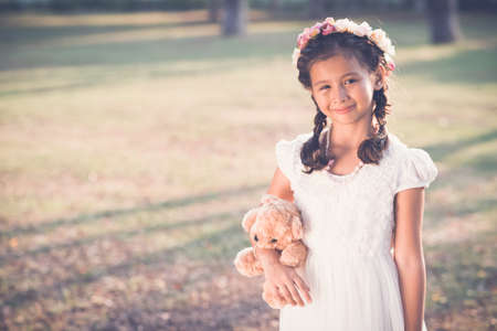 Portrait of smiling preteen girl standing on sunny meadowの写真素材