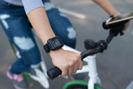 Woman checking her pulse when cycling, selective focusの写真素材