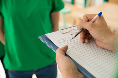Close-up image of woman filling volunteer formの写真素材