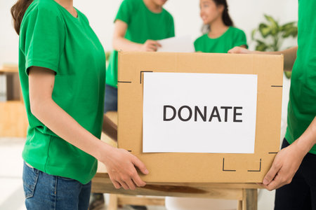 Volunteers carrying donate cardboard box