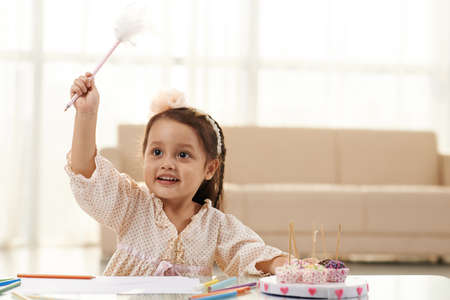 Girl pretending to practice witchcraft with her penの写真素材